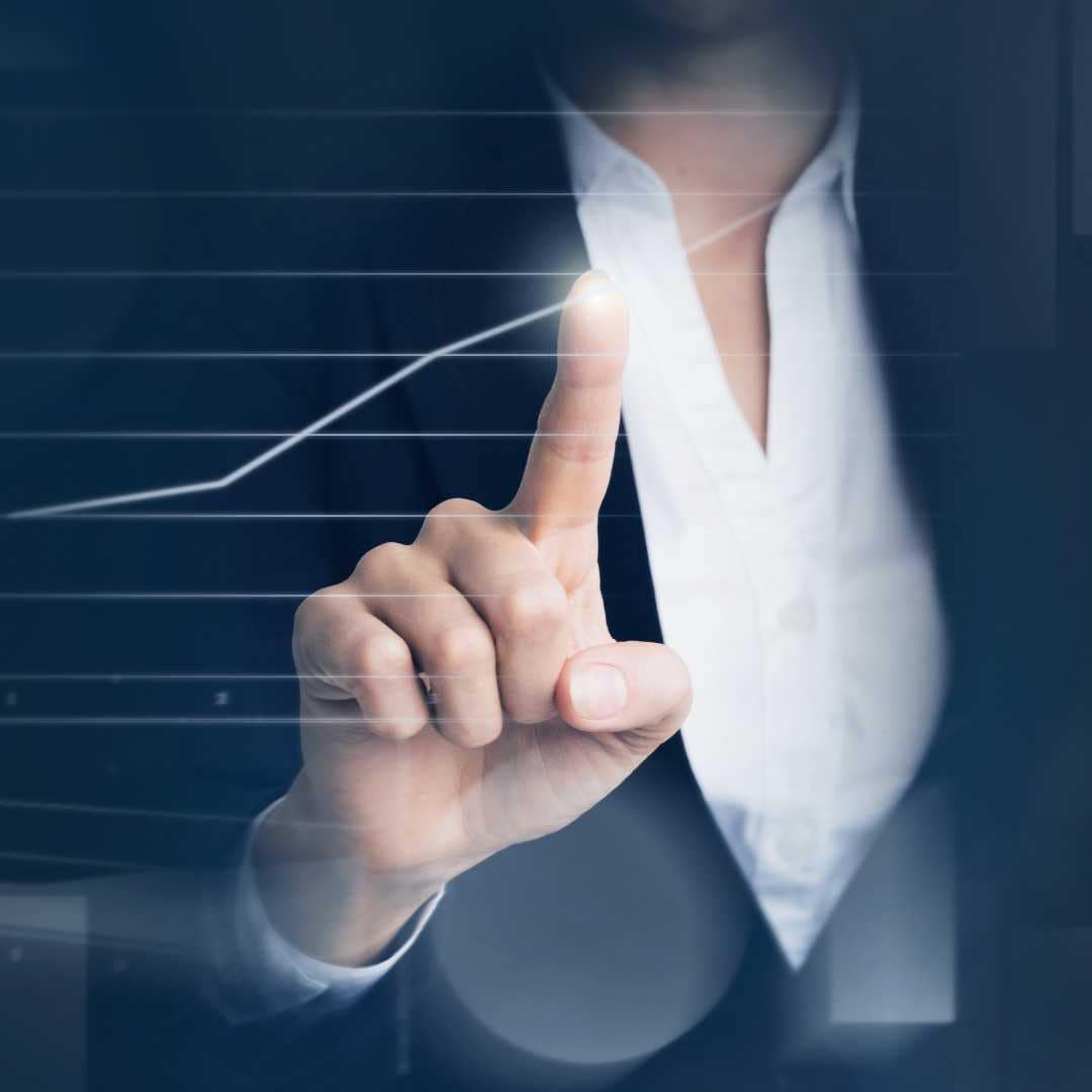 Business Woman pointing at upward trajectory of graph